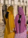 Ladies walking the marble promenade surrounding the temple pond.